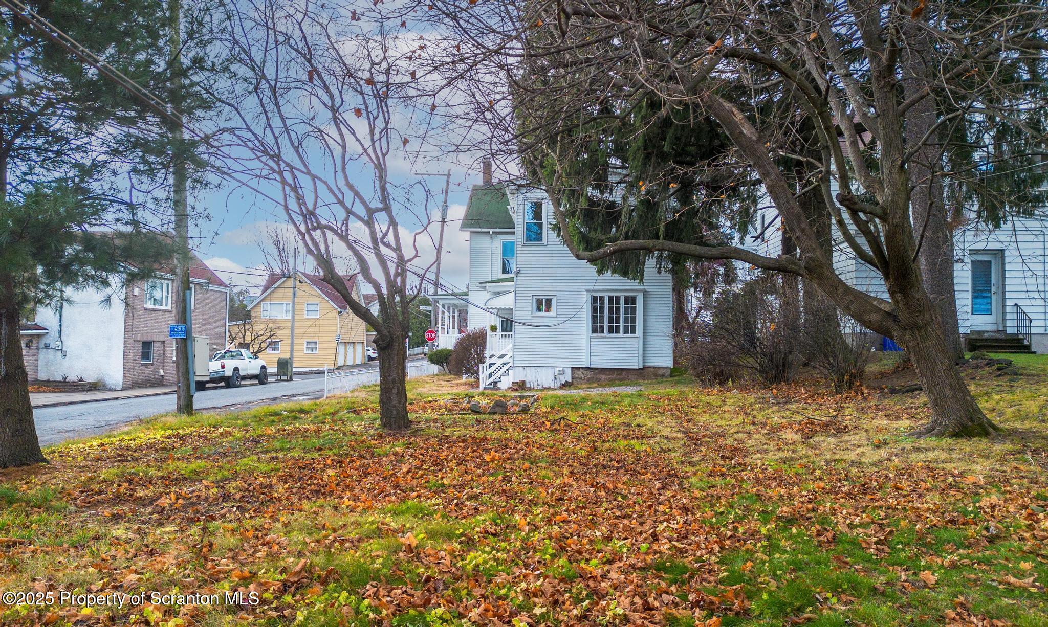 523 North Laurel Street Hazleton, PA 18201 - Photo 2 of 19 a tree in front of a white house
