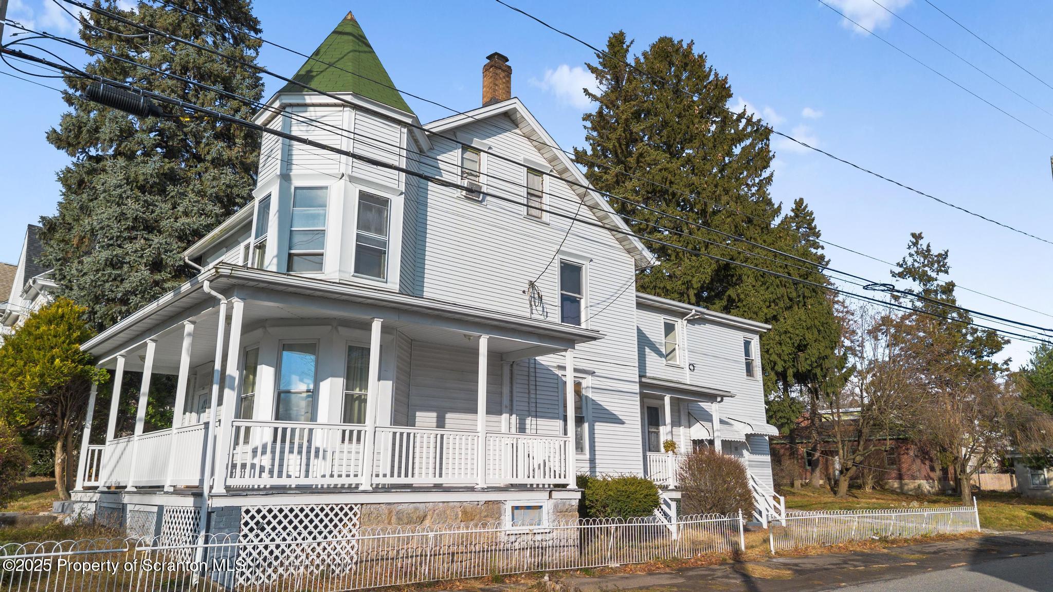 523 North Laurel Street Hazleton, PA 18201 - Photo 4 of 19 a view of a white house with large windows and a small yard
