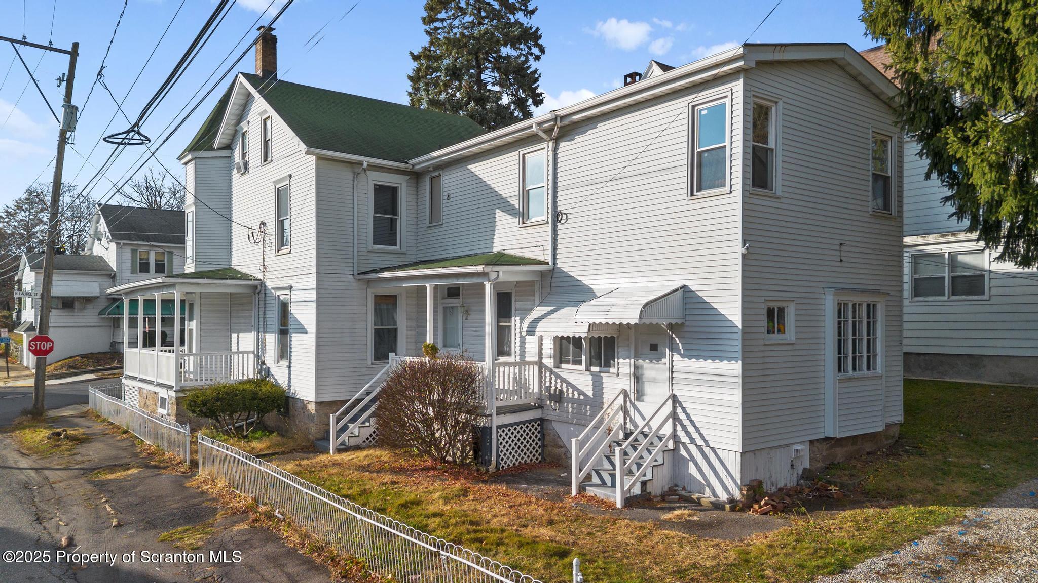 523 North Laurel Street Hazleton, PA 18201 - Photo 10 of 19 a view of a white house with large windows next to a road