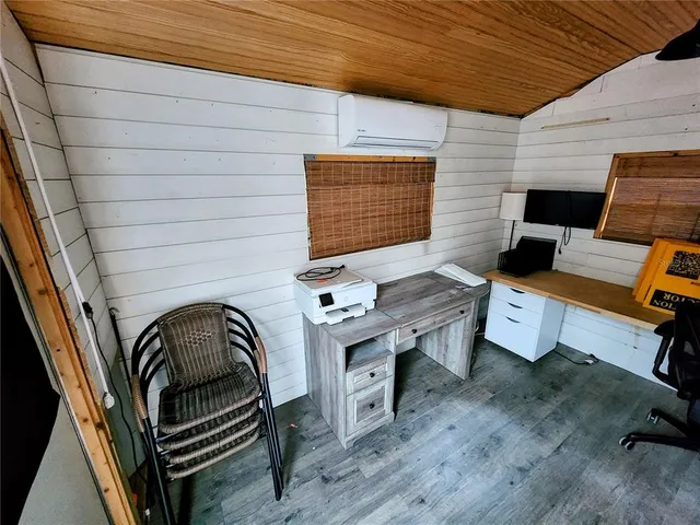 a view of a patio with table and chairs with wooden floor and fence