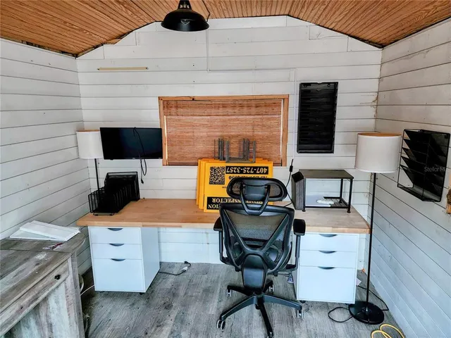 a work place with a chair and a flat screen tv