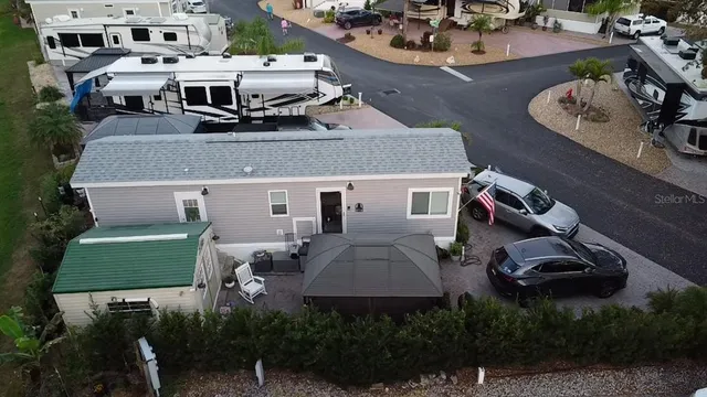 an aerial view of a house with garden space and street view