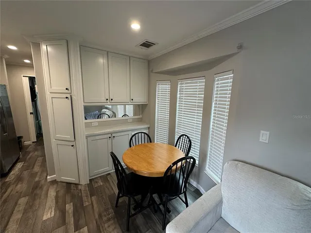 a view of a room with furniture and wooden floor