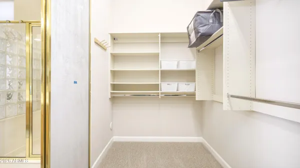 a view of walk in closet with empty racks