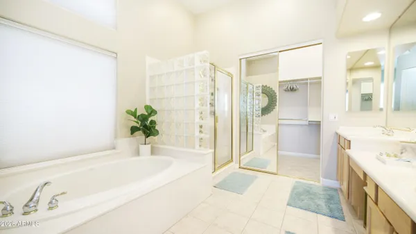 a spacious bathroom with a granite countertop tub shower and sink