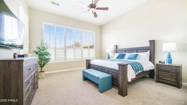 a spacious bedroom with a bed and a couch