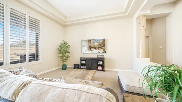 a spacious bedroom with a bed and a large window