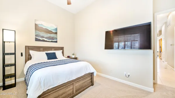 a bedroom with a bed and wall painting