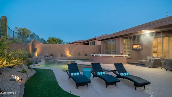 a swimming pool with outdoor seating and yard