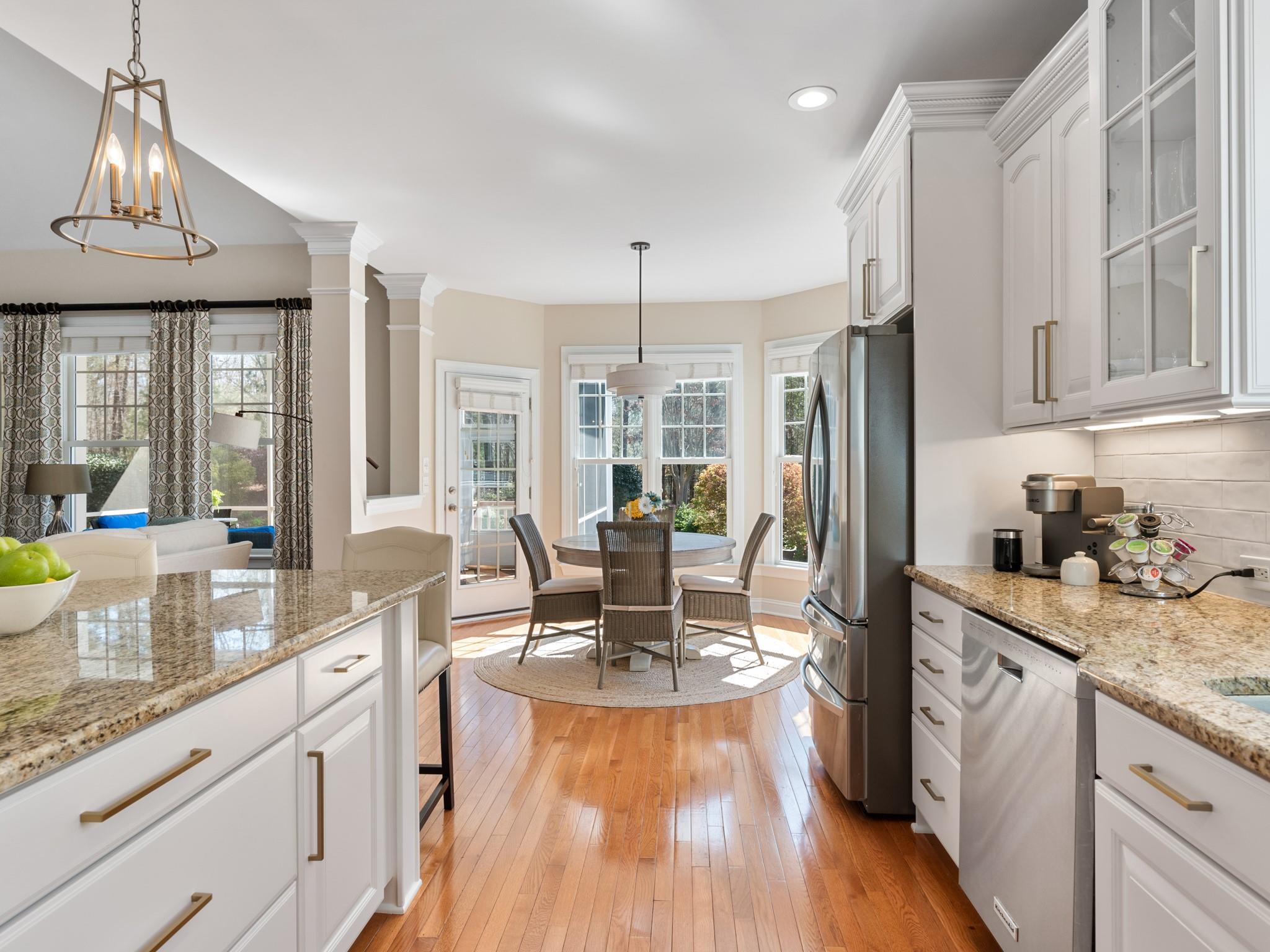 4300 Birkshire Heights Fort Mill, SC 29708 - Photo 10 of 40 a kitchen with stainless steel appliances granite countertop a refrigerator a sink dishwasher a stove and white countertops with wooden floor