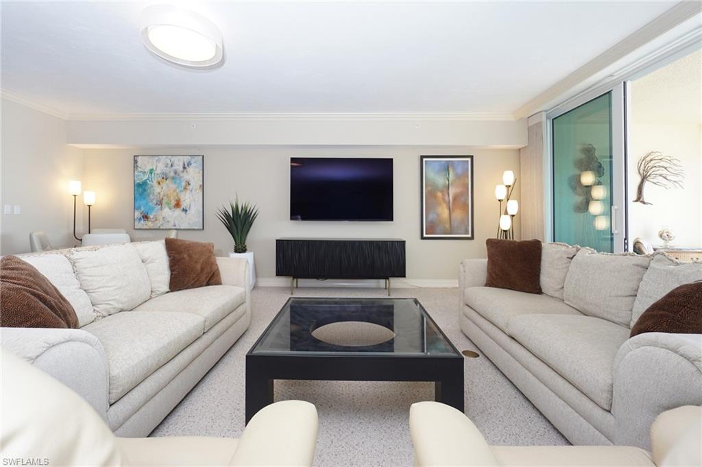 435 Dockside Drive, Unit B803 Naples, FL 34110 - Photo 13 of 35 Living room featuring crown molding and carpet flooring