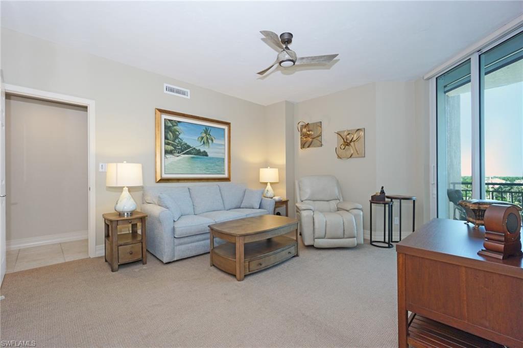 435 Dockside Drive, Unit B803 Naples, FL 34110 - Photo 20 of 35 Carpeted living room with ceiling fan