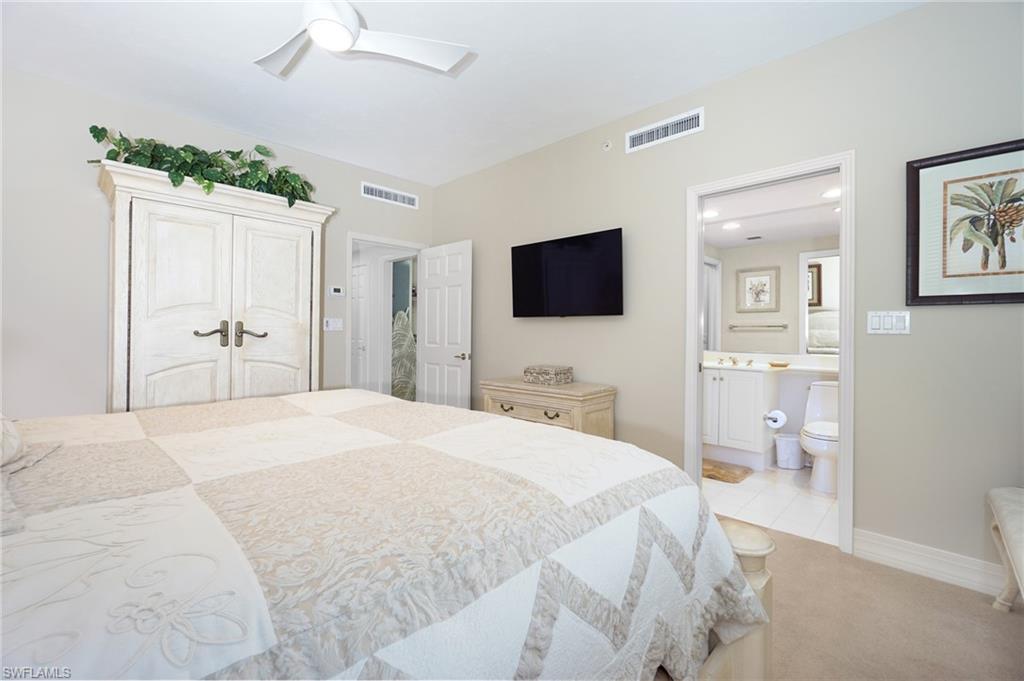 435 Dockside Drive, Unit B803 Naples, FL 34110 - Photo 27 of 35 Bedroom with ceiling fan, light colored carpet, ensuite bath, and a closet