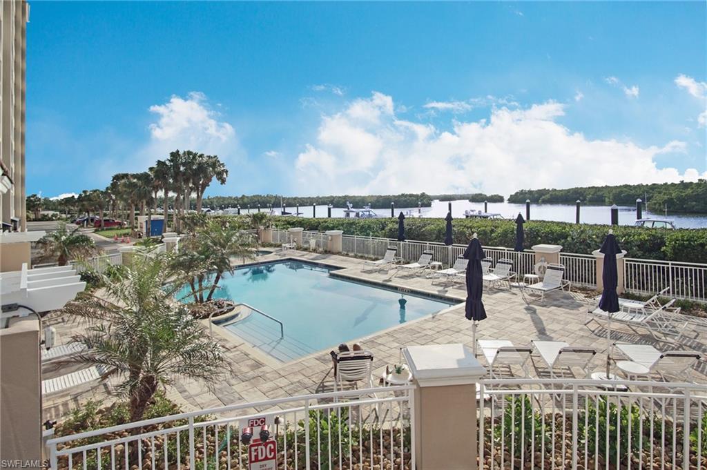 435 Dockside Drive, Unit B803 Naples, FL 34110 - Photo 32 of 35 View of swimming pool featuring a water view and a patio area