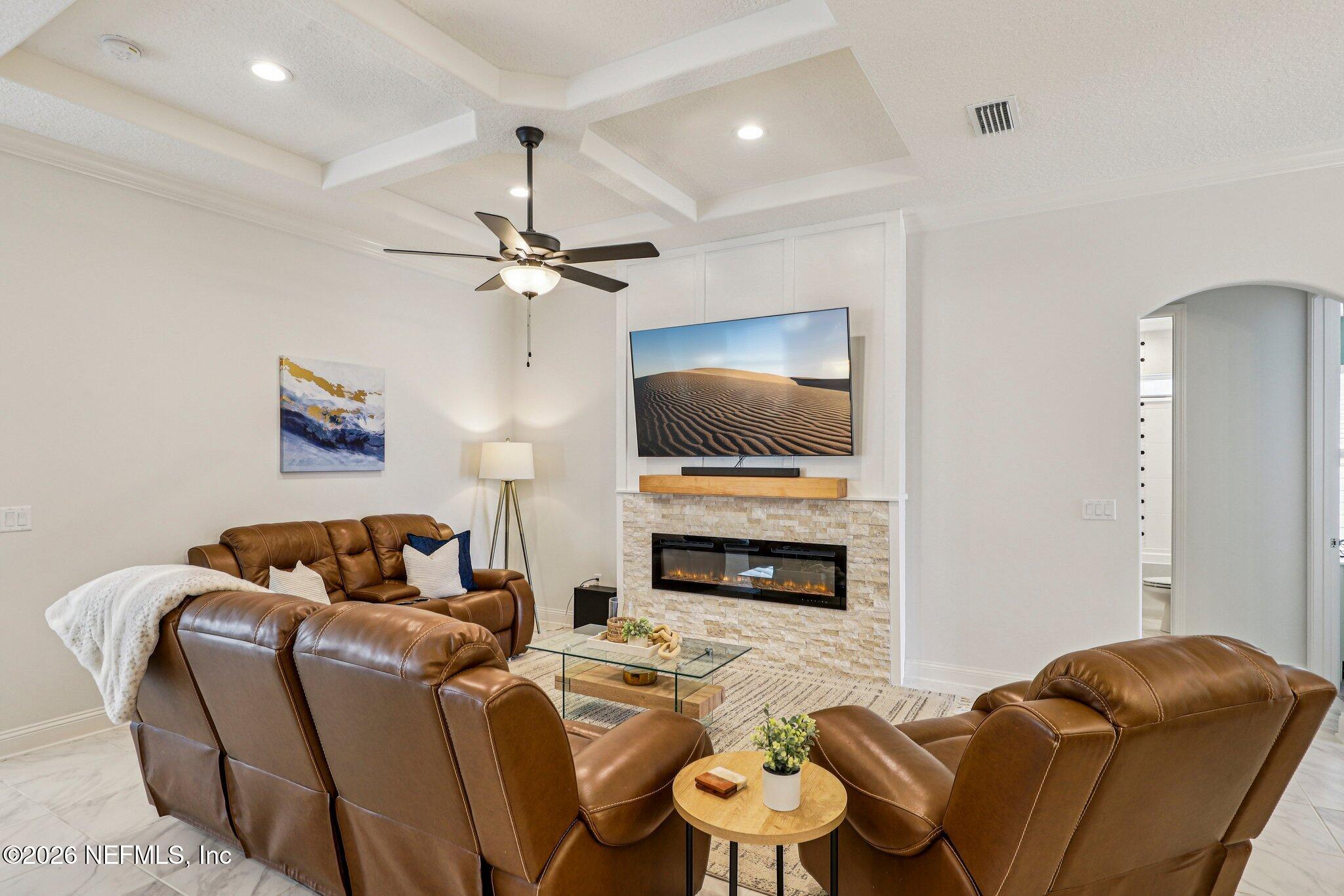 84 Firecrest Drive St. Augustine, FL 32092 - Photo 14 of 72 a living room with furniture a flat screen tv and a fireplace