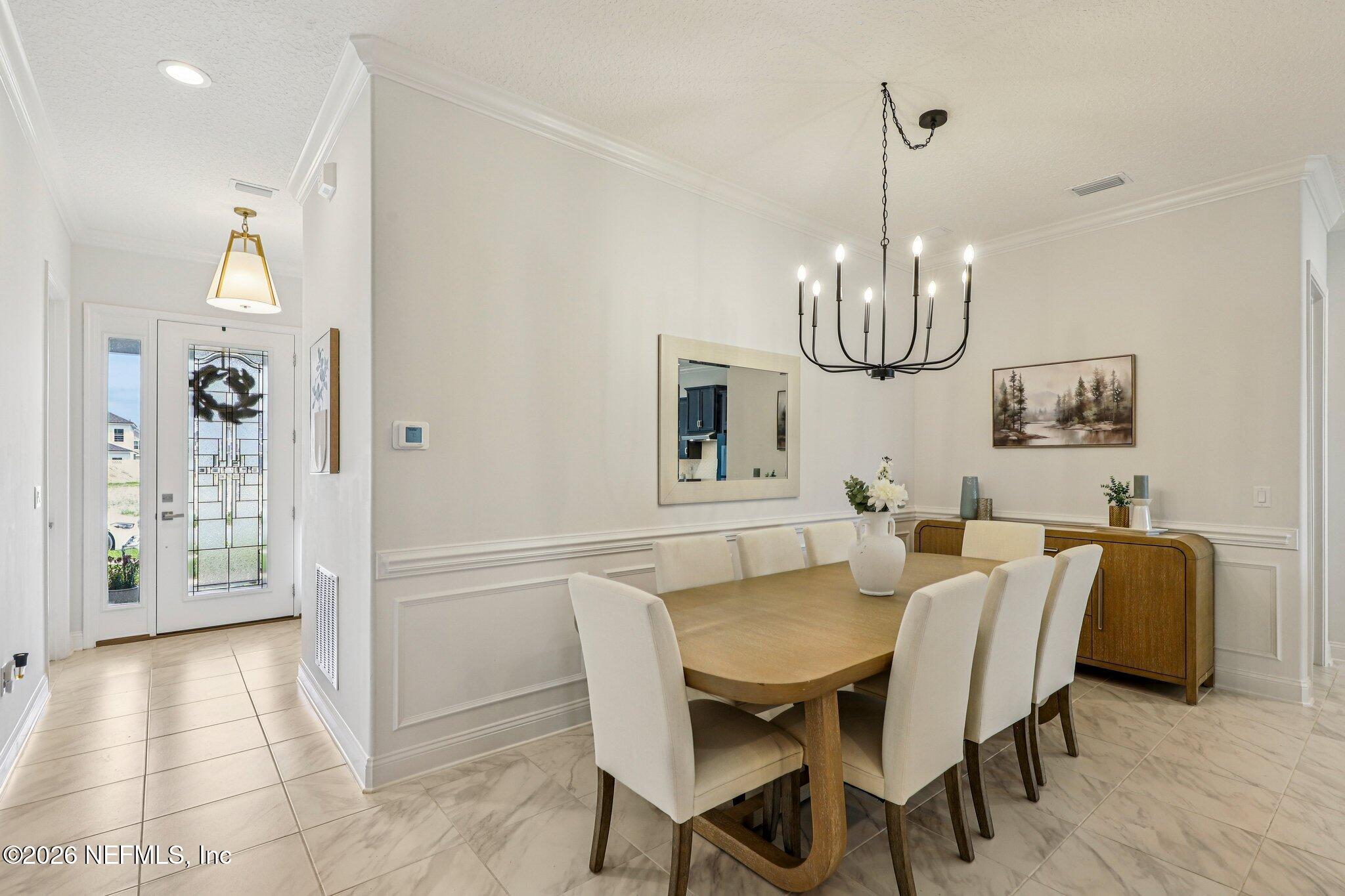 84 Firecrest Drive St. Augustine, FL 32092 - Photo 19 of 72 a view of a dining room with furniture and chandelier