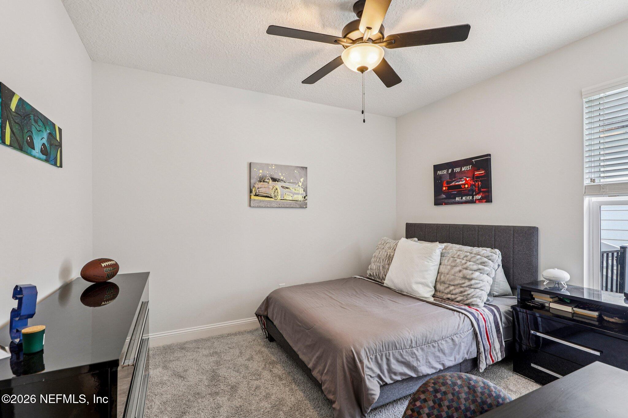 84 Firecrest Drive St. Augustine, FL 32092 - Photo 27 of 72 a bedroom with a bed and a wall painting