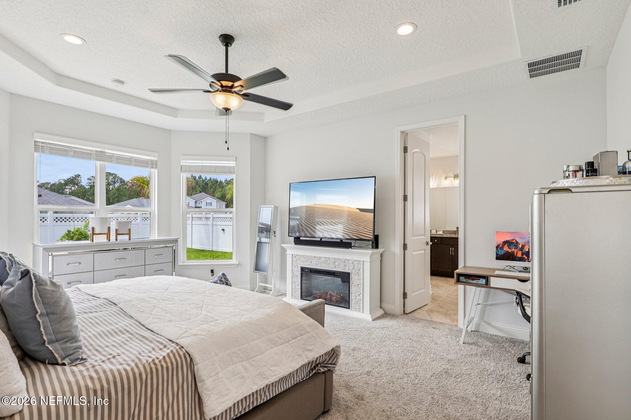 84 Firecrest Drive St. Augustine, FL 32092 - Photo 36 of 72 a bedroom with a bed and a fireplace