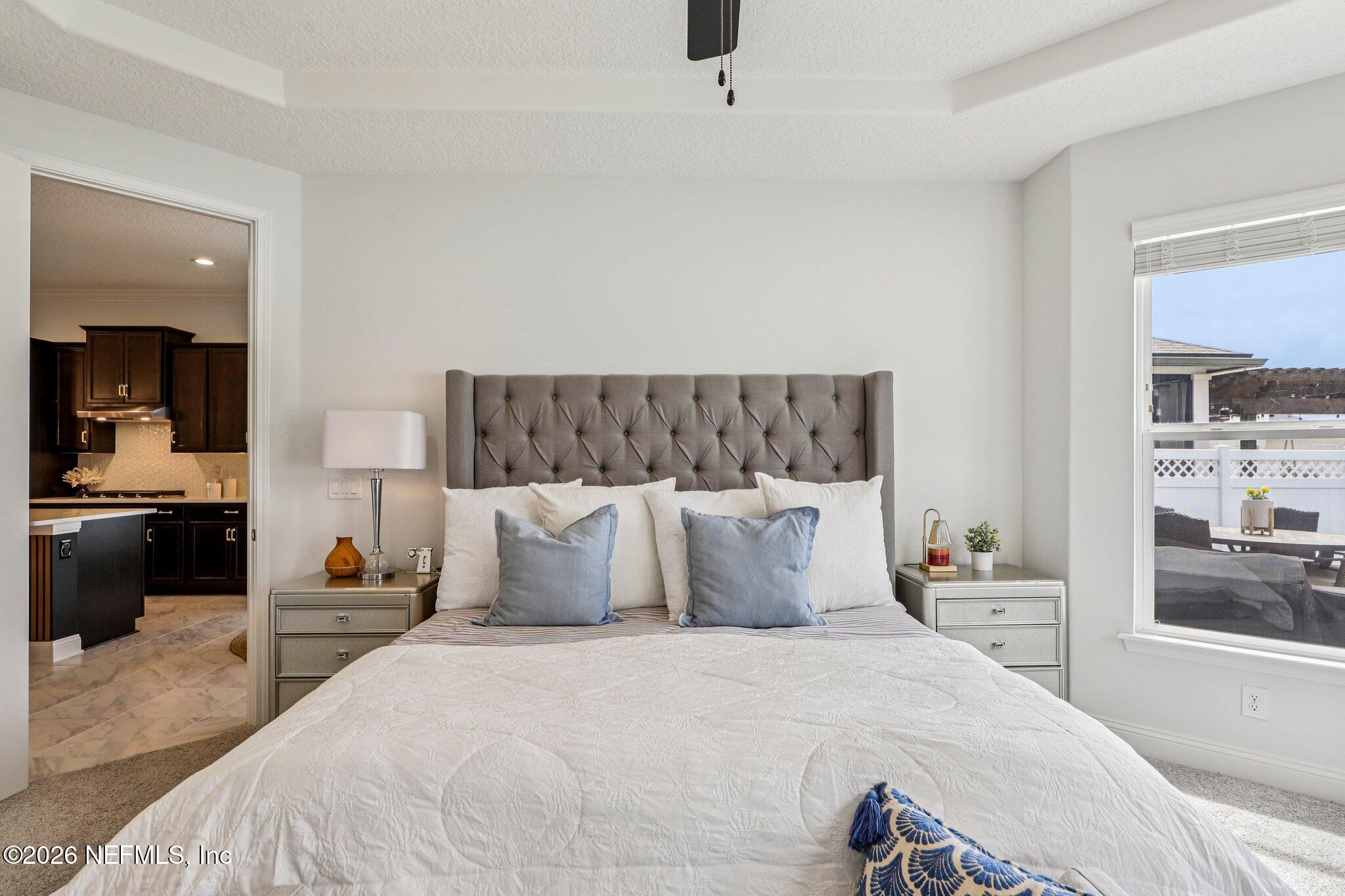 84 Firecrest Drive St. Augustine, FL 32092 - Photo 37 of 72 a bedroom with a large bed and a view of kitchen
