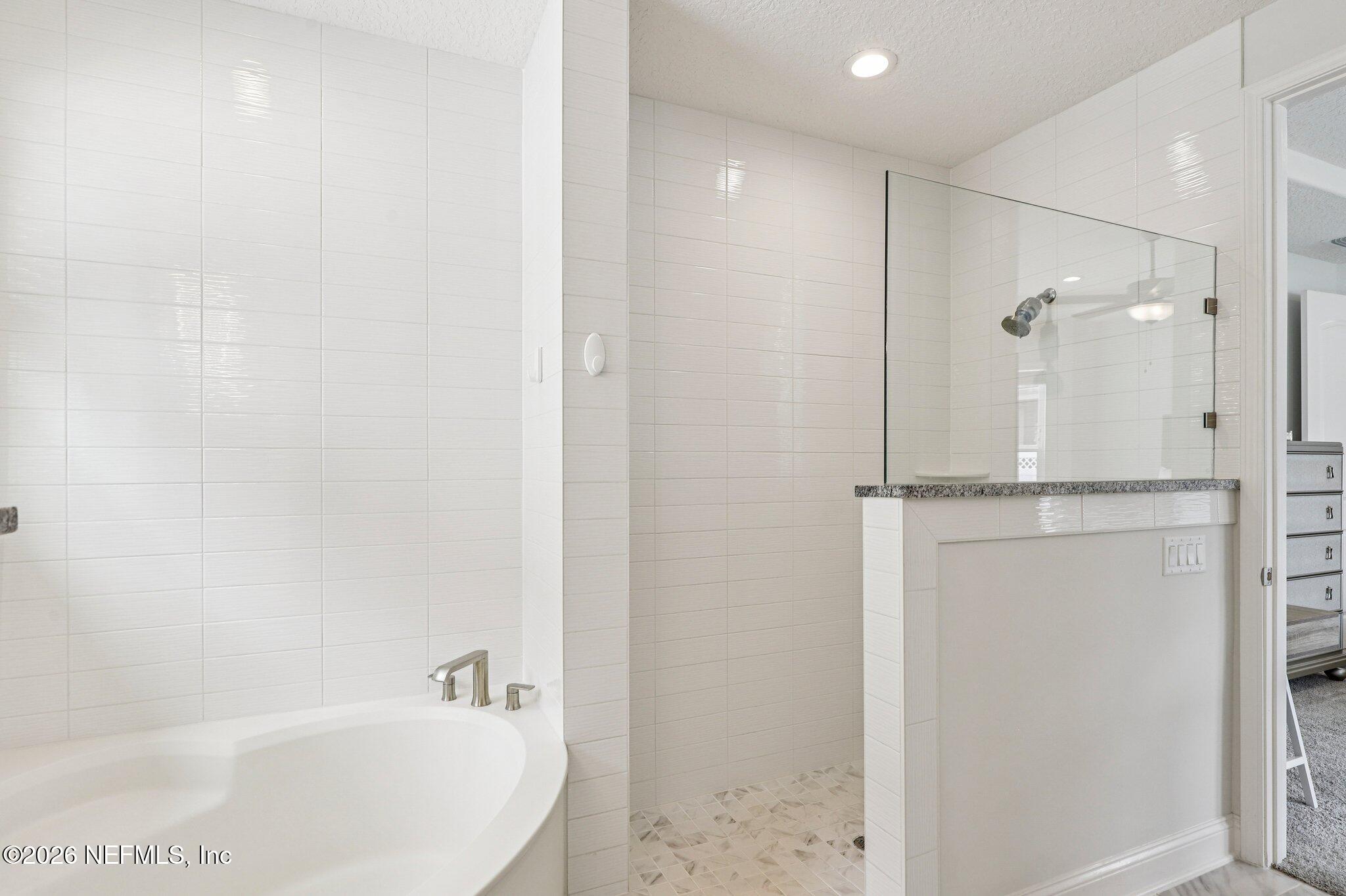 84 Firecrest Drive St. Augustine, FL 32092 - Photo 39 of 72 a bathroom with a bathtub and a shower