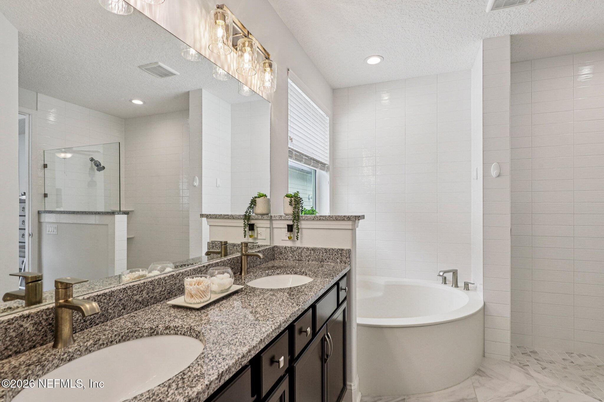 84 Firecrest Drive St. Augustine, FL 32092 - Photo 7 of 72 a bathroom with a granite countertop sink and a mirror