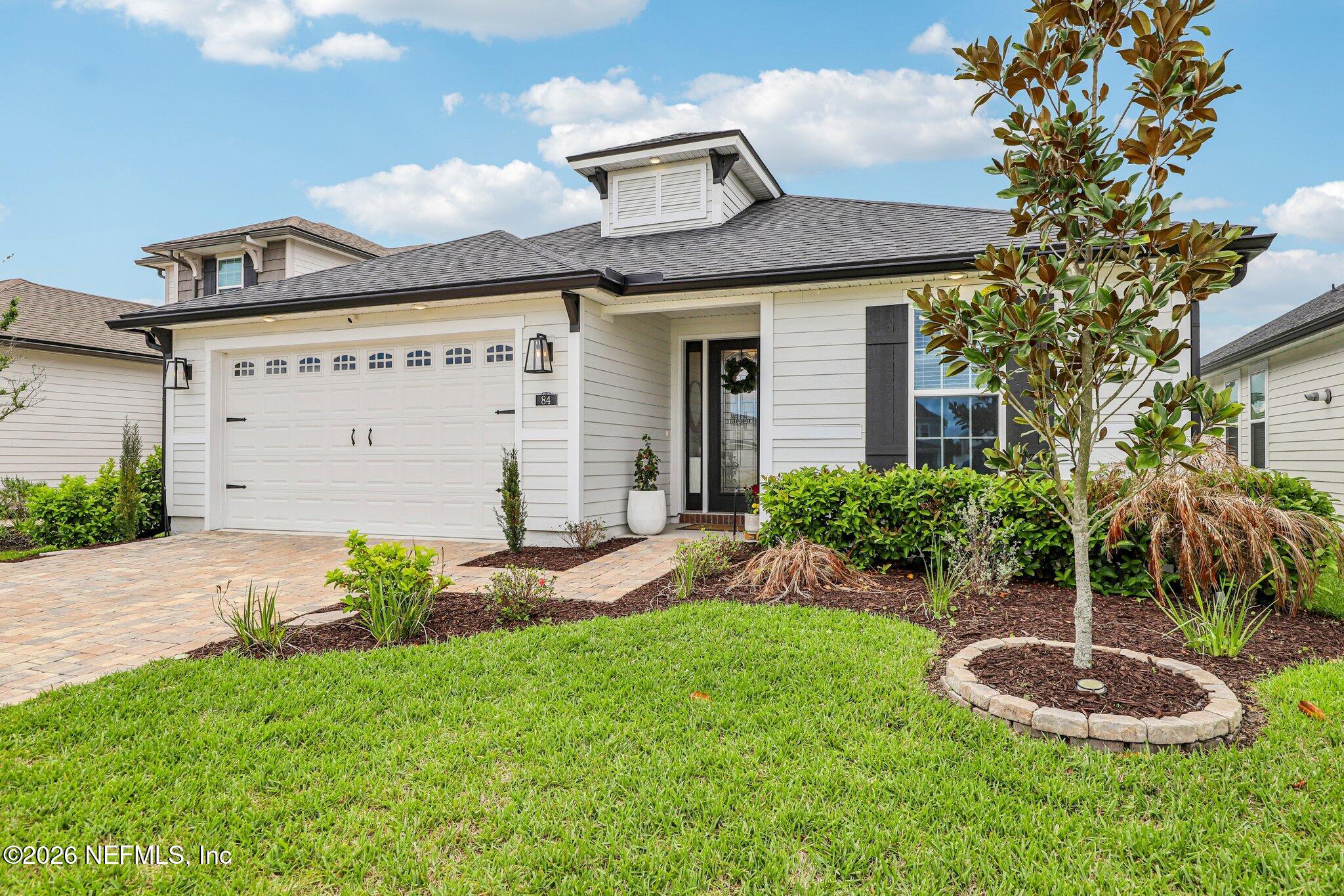 84 Firecrest Drive St. Augustine, FL 32092 - Photo 10 of 72 a front view of a house with a yard and garage
