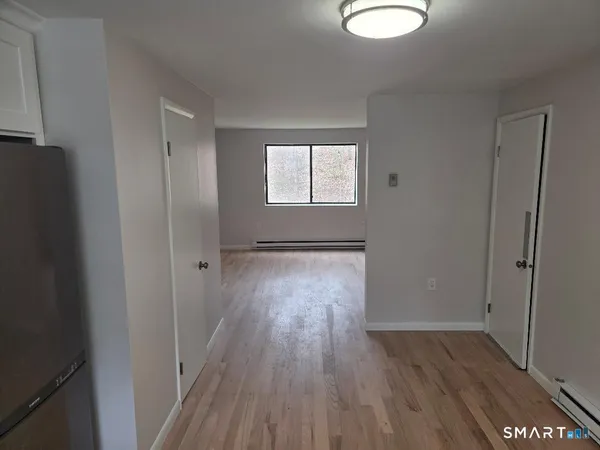 a view of hallway with wooden floor