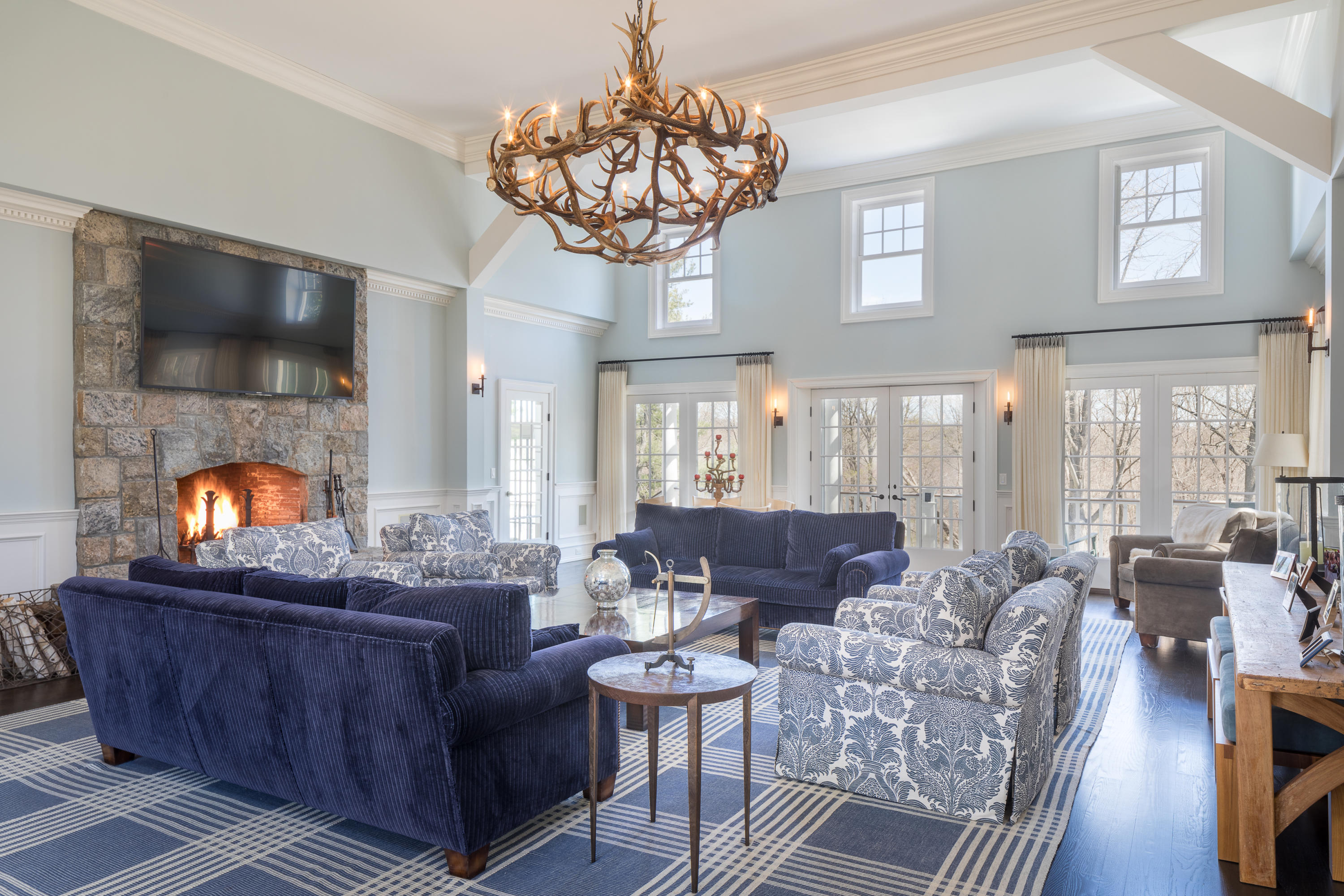 289 Oenoke Ridge New Canaan, CT 06840 - Photo 15 of 39 a living room with furniture a chandelier and a fireplace