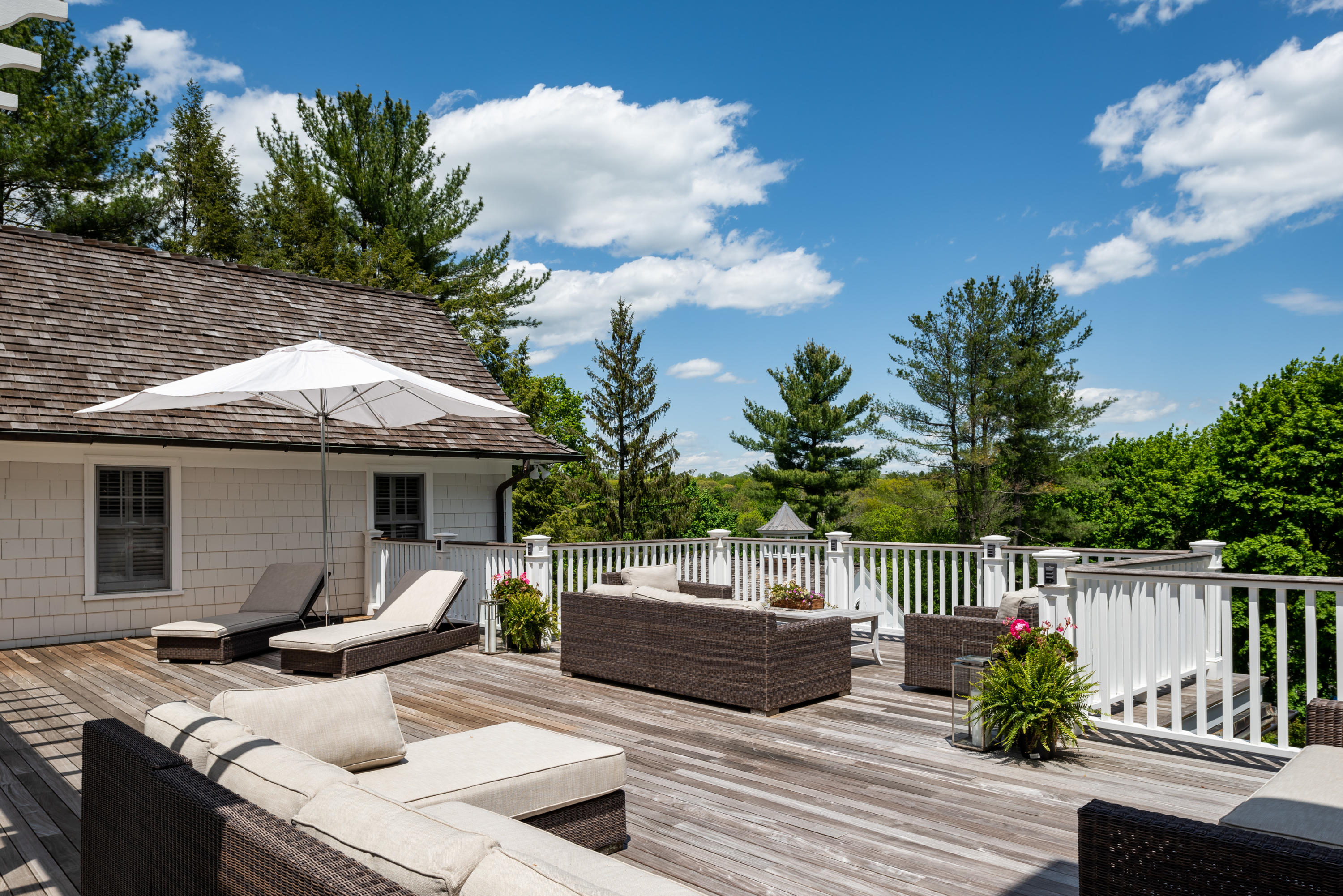 289 Oenoke Ridge New Canaan, CT 06840 - Photo 22 of 39 a view of a chair and tables back yard of the house
