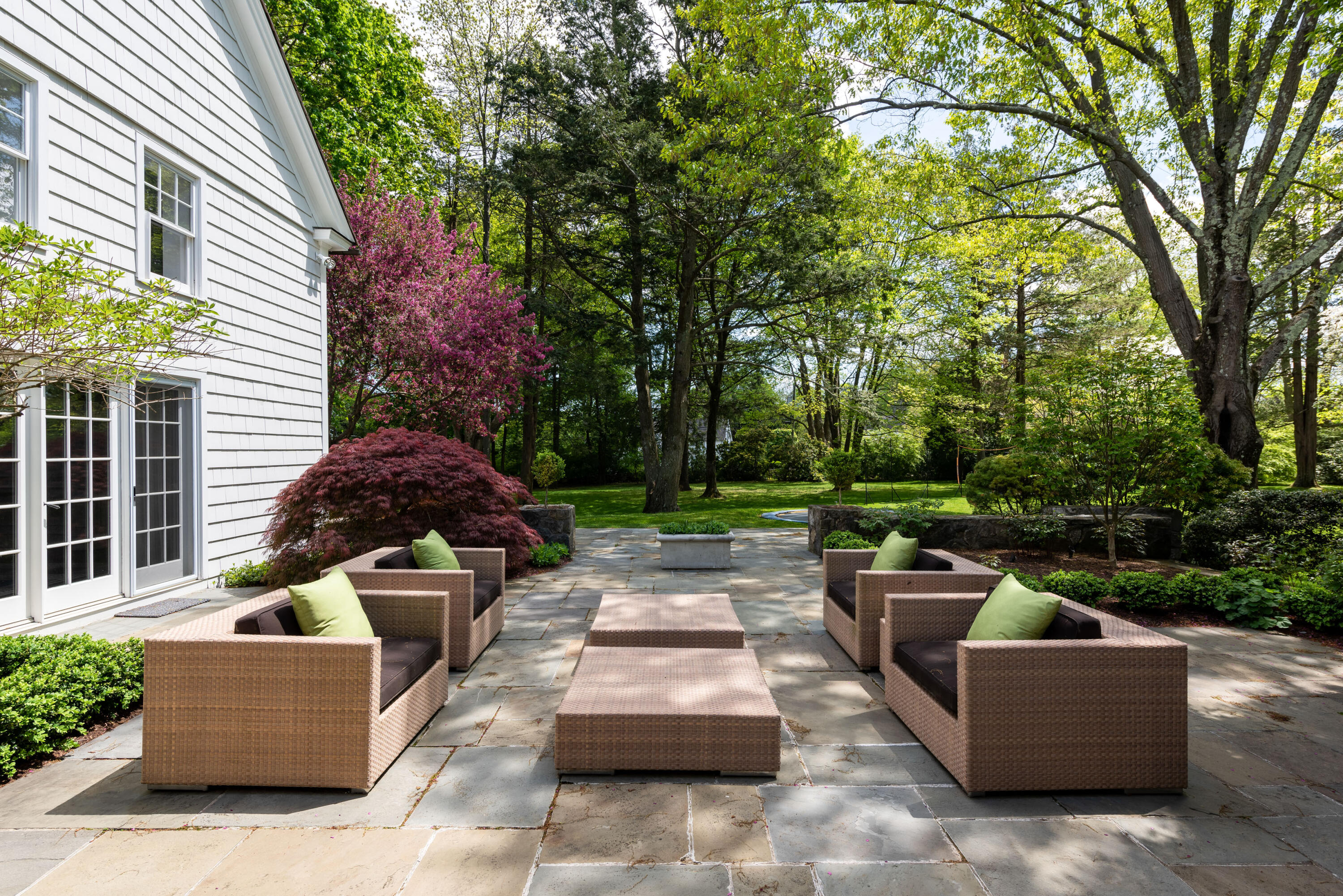 289 Oenoke Ridge New Canaan, CT 06840 - Photo 26 of 39 a view of a patio with couches and a fire pit