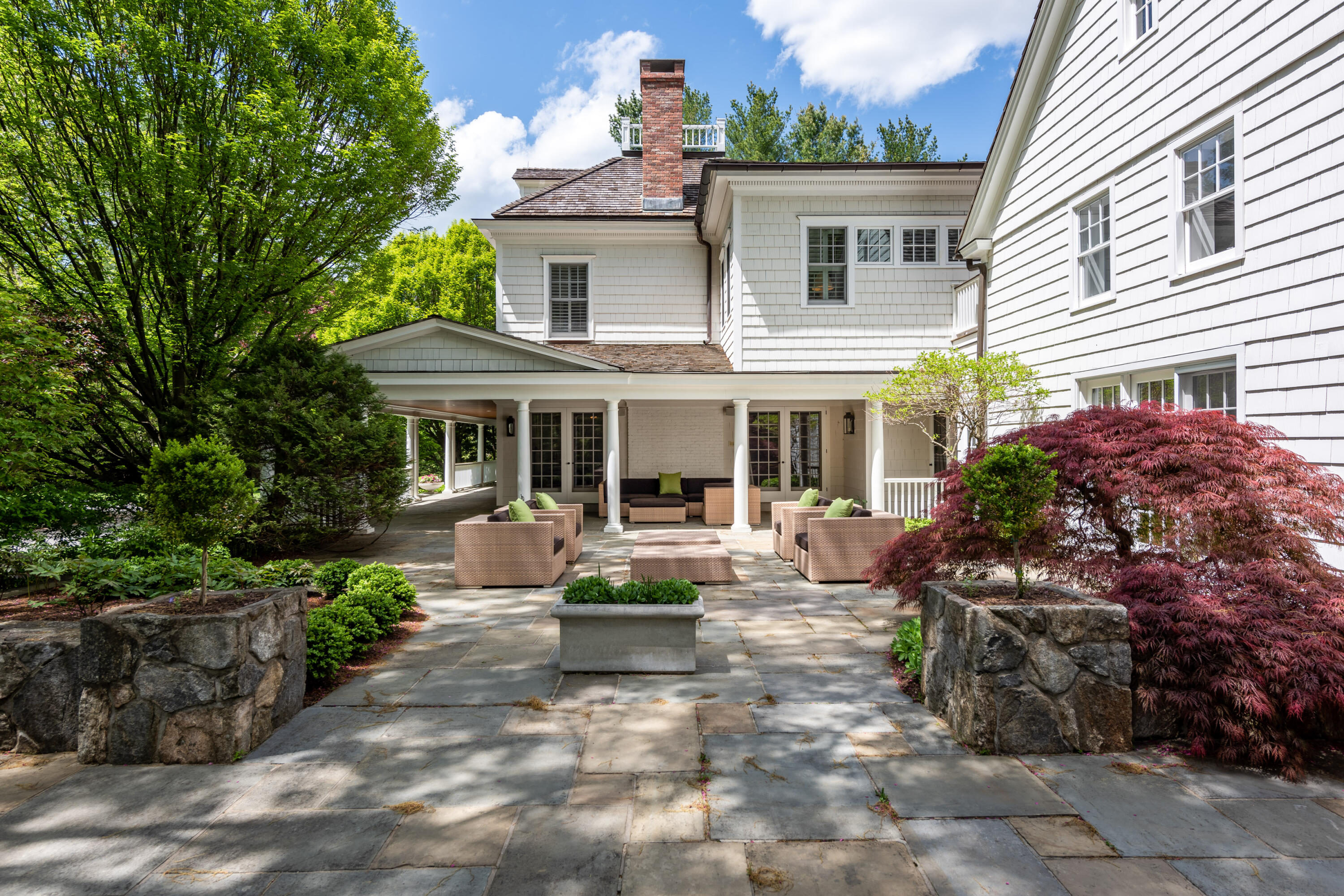 289 Oenoke Ridge New Canaan, CT 06840 - Photo 27 of 39 a view of a house with sitting area and garden