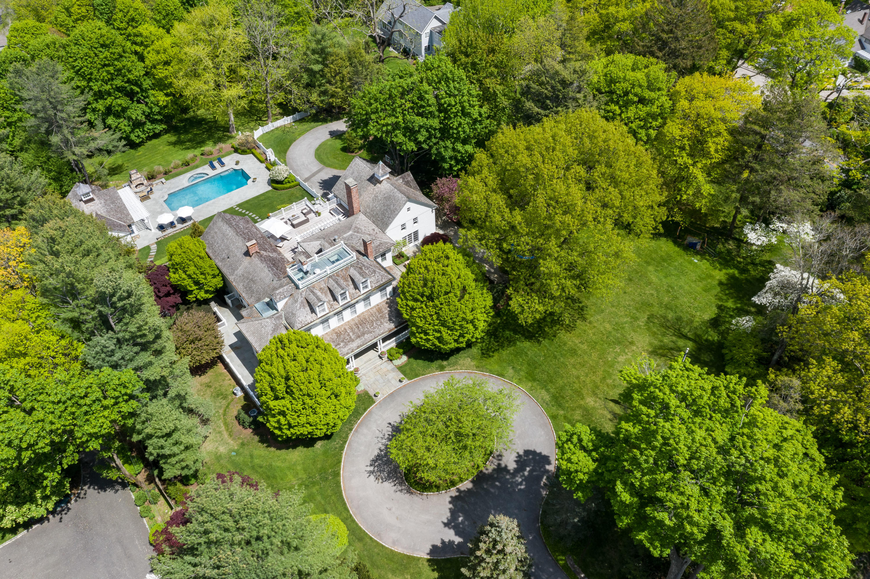 289 Oenoke Ridge New Canaan, CT 06840 - Photo 37 of 39 an aerial view of a house with a garden and swimming pool