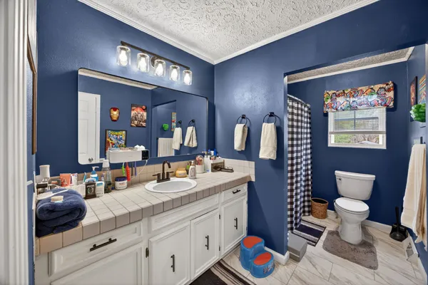 a bathroom with a toilet a sink and a mirror
