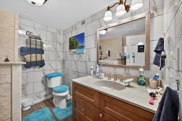 a bathroom with a sink toilet and shower