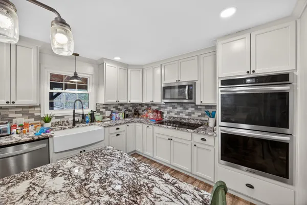 a kitchen with a sink stove and microwave