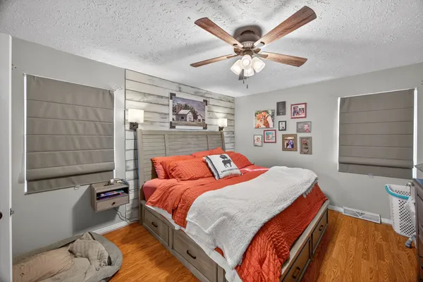 a bedroom with a bed and a chandelier