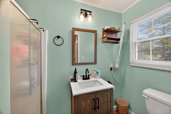 a bathroom with a toilet sink and mirror