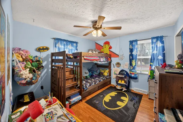 a bed room with furniture and a flat screen tv