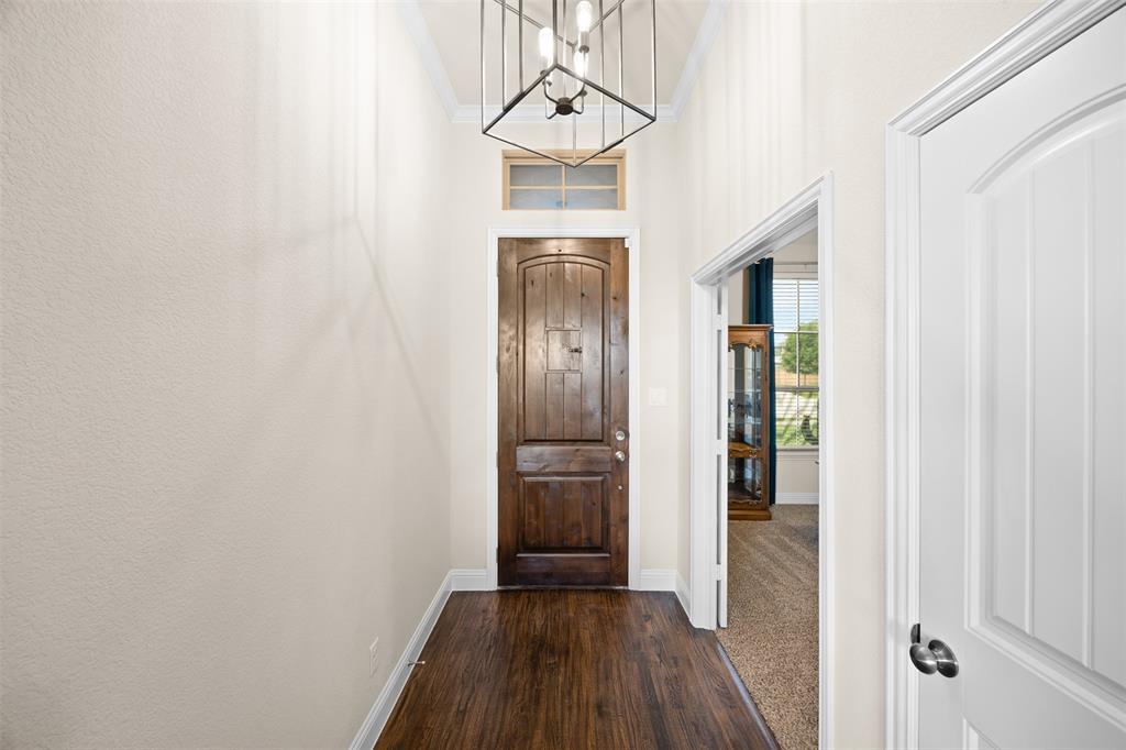 2618 Byrd Ranch Road Midlothian, TX 76065 - Photo 5 of 38 a view of a hallway with wooden floor and staircase