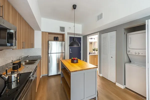 a kitchen with refrigerator cabinets and wooden floor