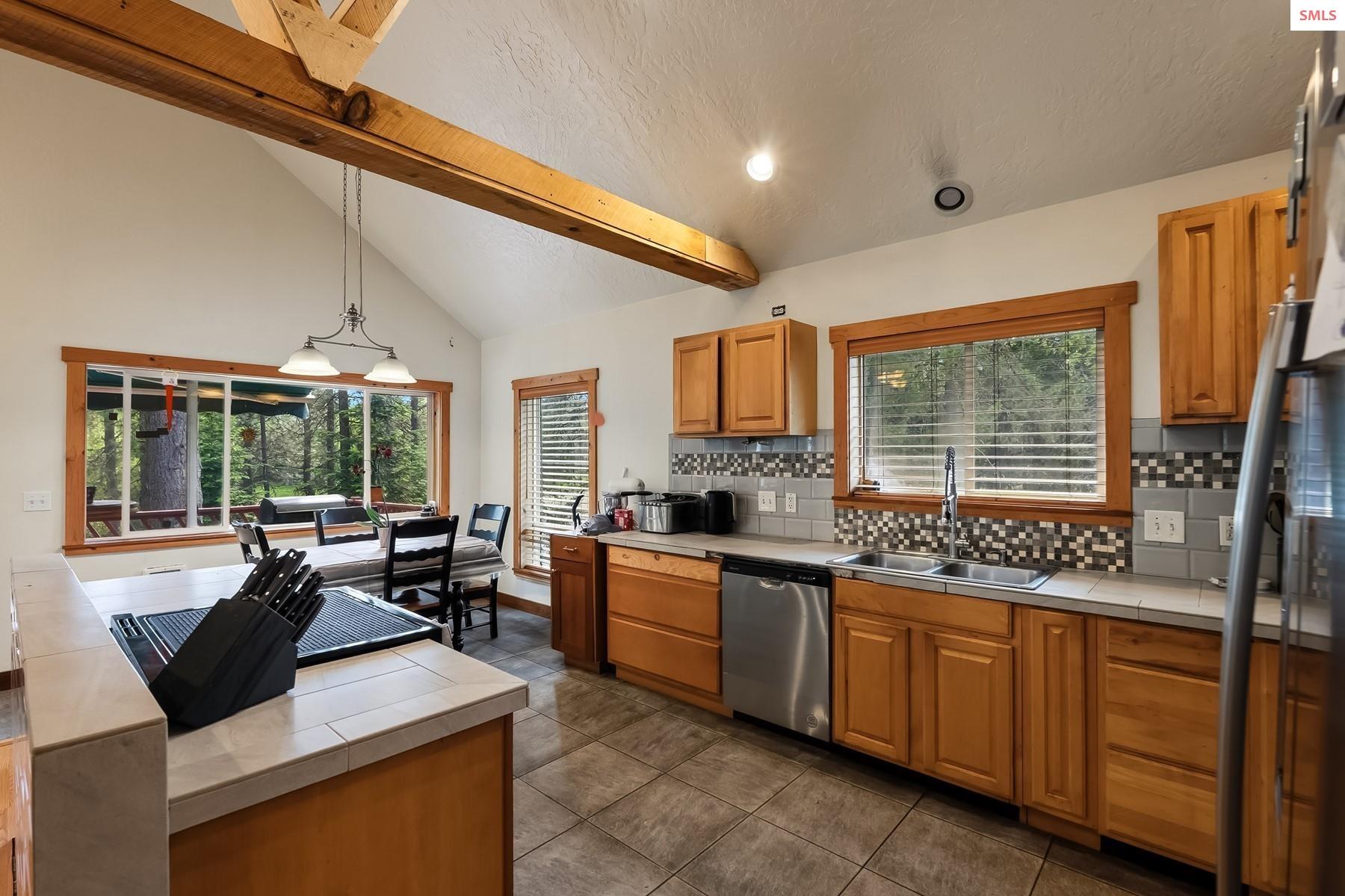 2206 Gypsy Bay Road Sagle, ID 83860 - Photo 3 of 42 New Appliances and lots of light make meal time with family and friends something special