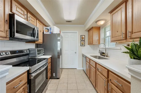 a kitchen with a sink stove and microwave