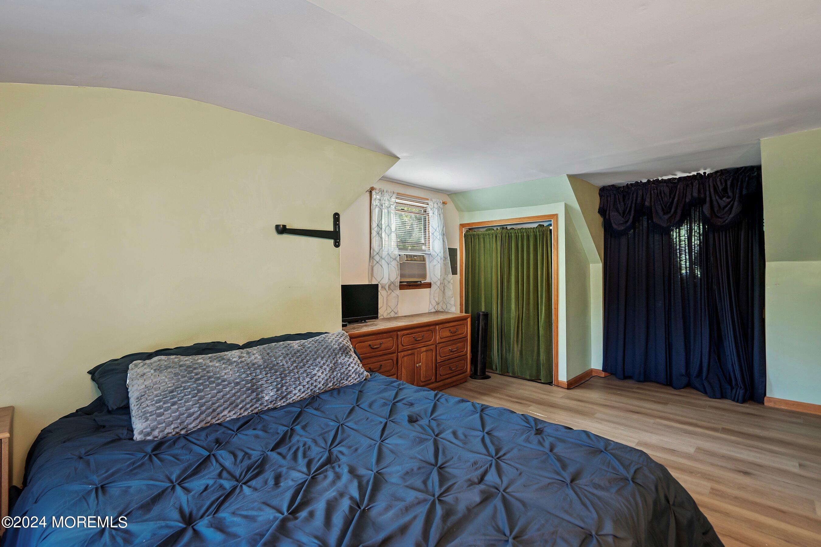 1220 Lewis Road Point Pleasant, NJ 08742 - Photo 18 of 28 a bedroom with a bed and a dresser