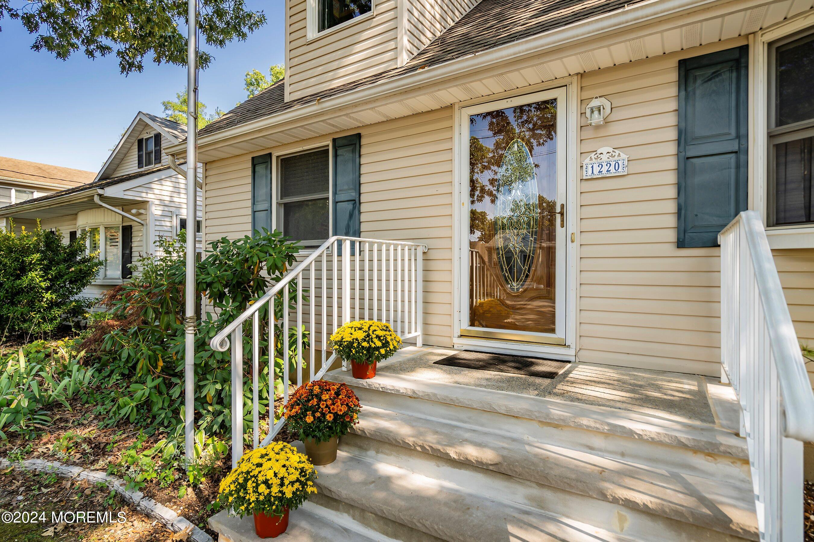 1220 Lewis Road Point Pleasant, NJ 08742 - Photo 4 of 28 a front view of a house with a garden