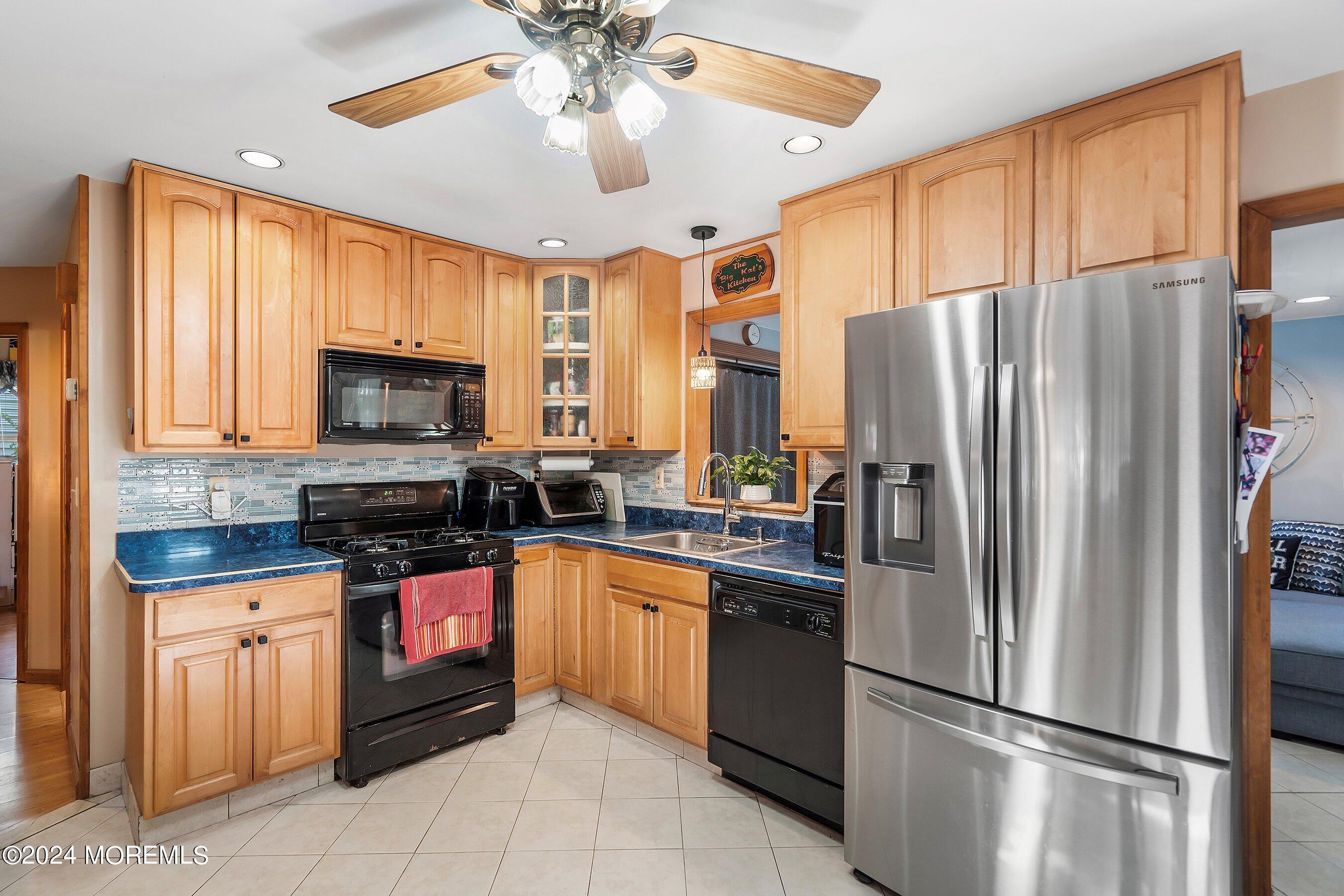 1220 Lewis Road Point Pleasant, NJ 08742 - Photo 10 of 28 a kitchen with stainless steel appliances granite countertop a refrigerator stove microwave and sink