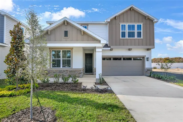 a front view of a house with a garden and yard