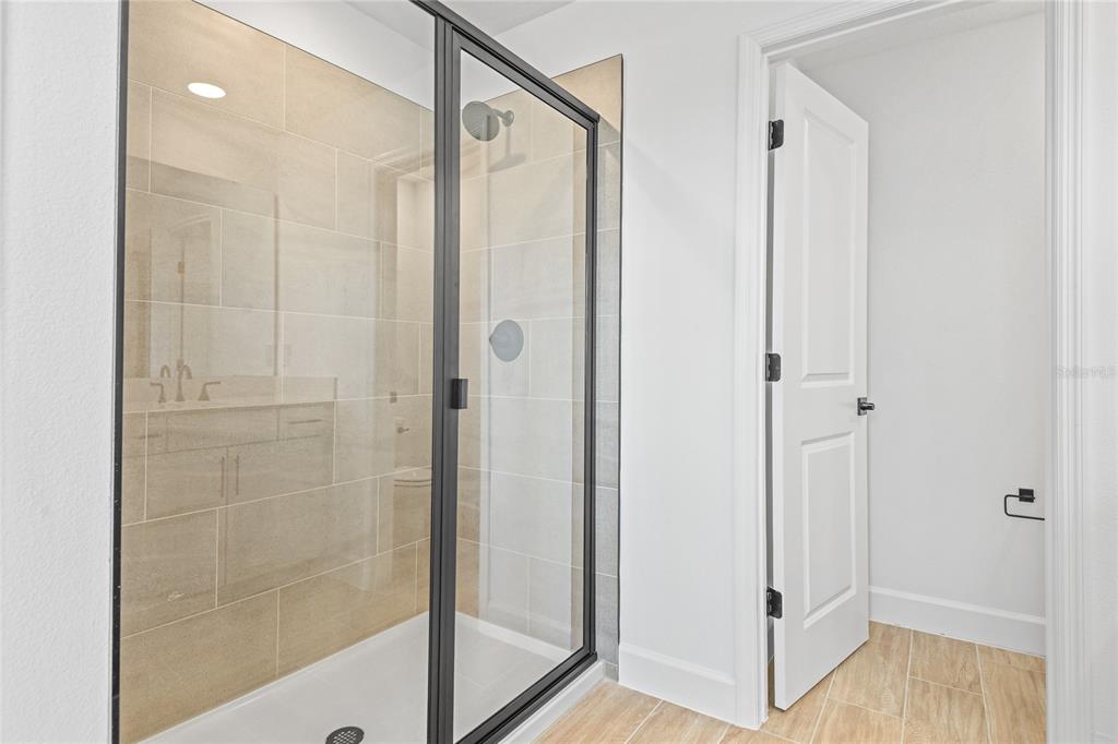 151 Waterstone Loop Tavares, FL 32778 - Photo 17 of 20 a bathroom with a glass shower door