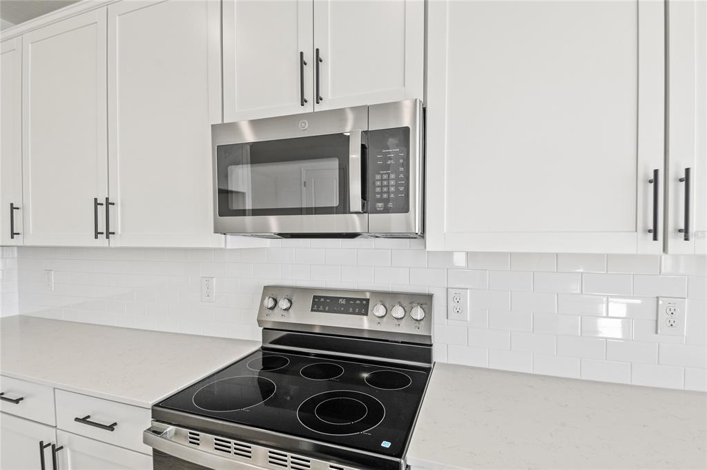 151 Waterstone Loop Tavares, FL 32778 - Photo 7 of 20 a stove top oven sitting inside of a kitchen