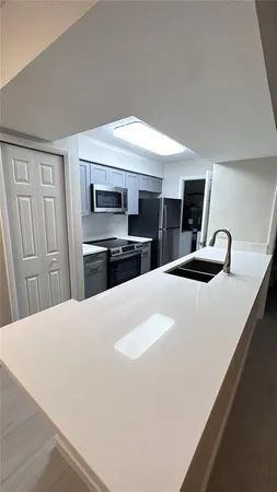 a kitchen with stainless steel appliances a refrigerator and a stove top oven