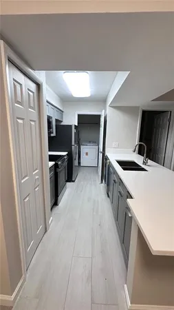 a kitchen with stainless steel appliances a refrigerator a sink dishwasher stove and oven